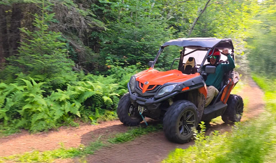 A man rides a UTV in the backcountry.